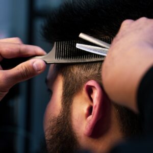 a man with a beard and a hair clipper on his head
