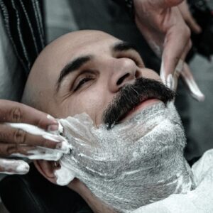 A man getting his hair cut by a barber